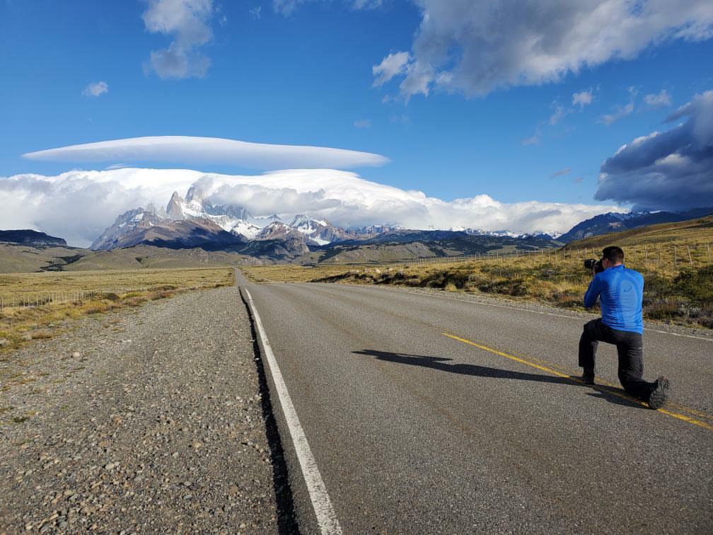 Photographer Derek Nielsen taking a photo of mountains in Patagonia