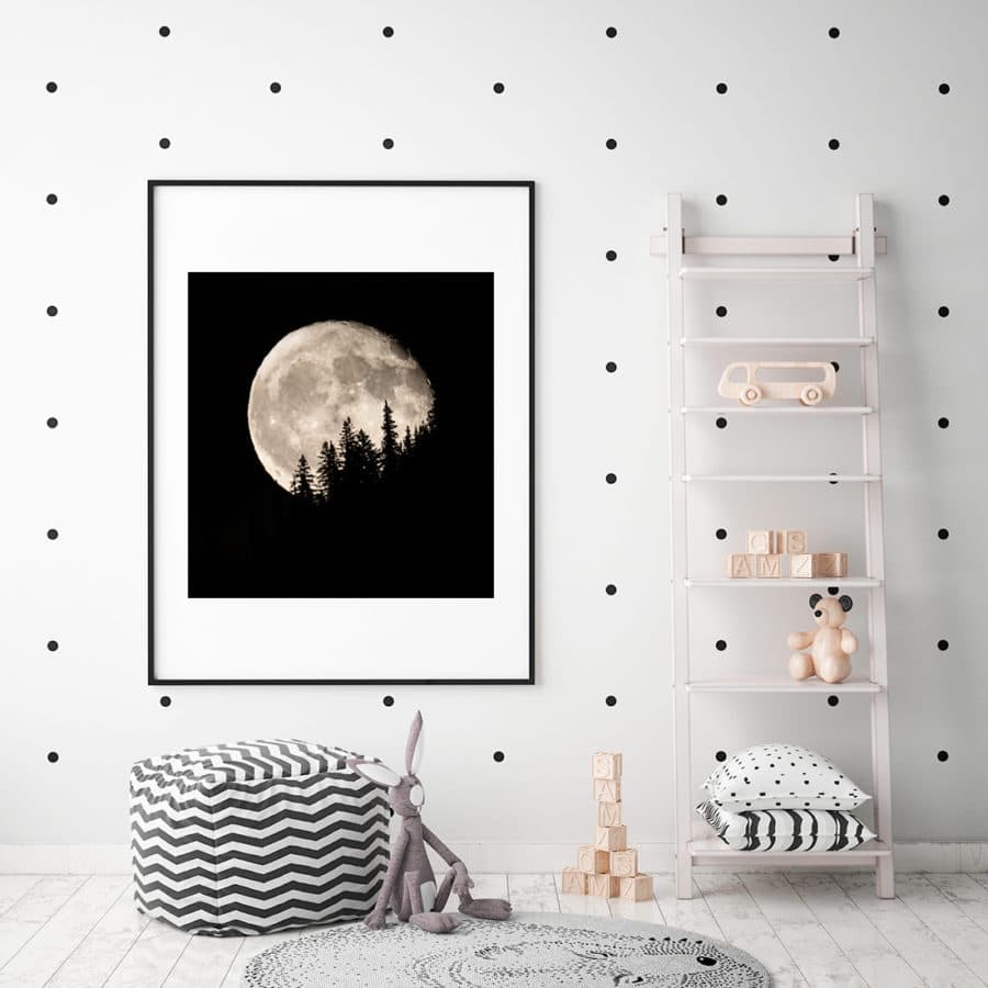 framed image of a rising full moon displayed in a Childs nursery 