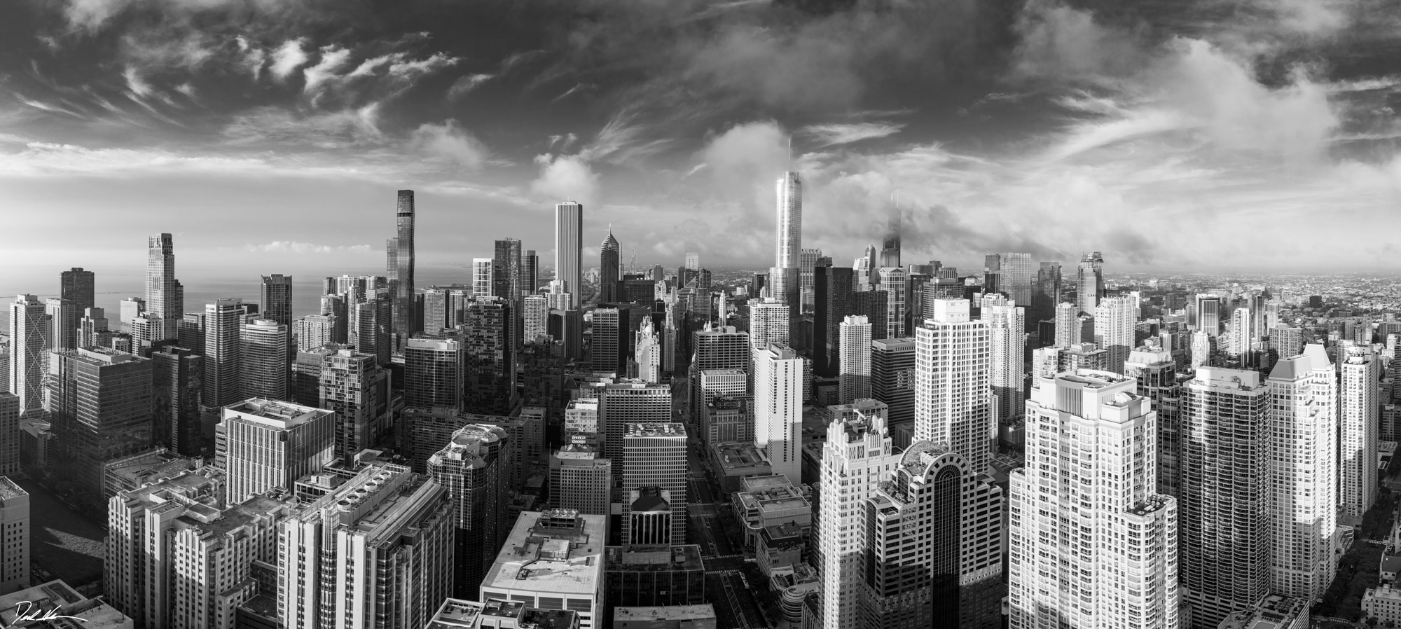 large panoramic black and white image of Chicago taken high above the city from Chicago Avenue looking south over the whole city