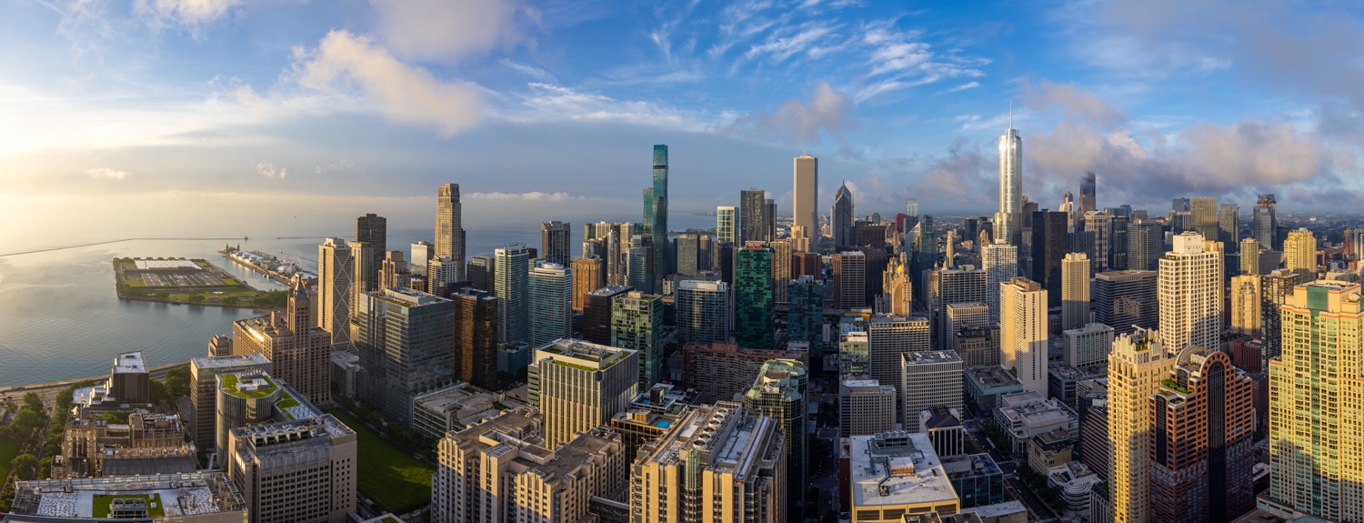 panoramic image of Chicago skyline at sunrise taken from the top of 161 E Chicago giving a view of the whole city