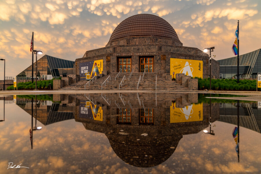 beautiful photo of Adler Planetarium at sunset with a perfect reflection of the building and clouds in frame