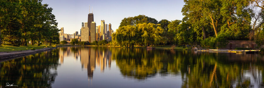 panoramic image of the lagoon at Lincoln Park in Chicago giving a perfect reflection of the city and the John Hancock building