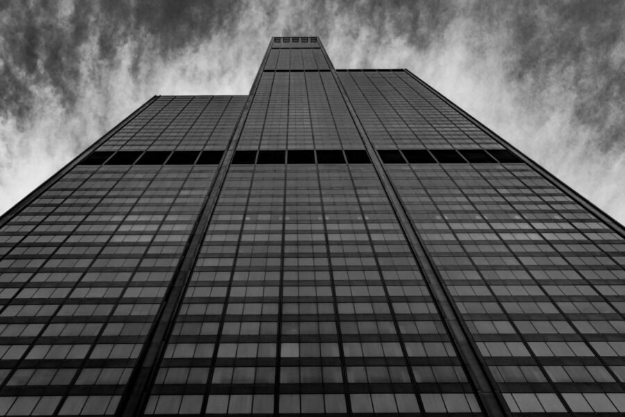 Black and white image of the Sears Tower / Willis Tower in Chicago taken from at the base of the building looking up