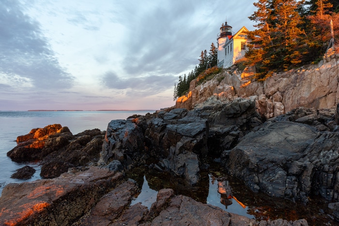image of a gorgeous sunrise in Acadia National Park Maine with a lighthouse in the image