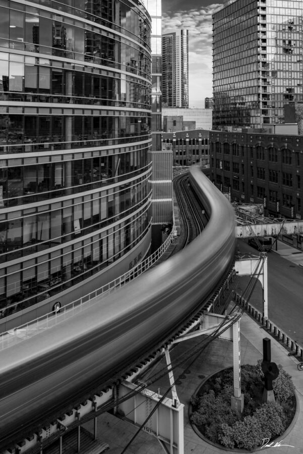 black and white image of an elevated train in Chicago making a long S turn through the River North neighborhood 