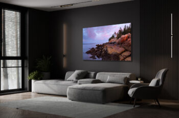 large unframed print of Bass Harbor Lighthouse in Maine displayed above the couch in the living room of a luxury home