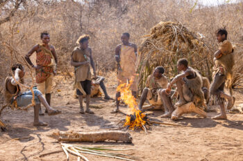 Hadzabe tribal members standing around fire