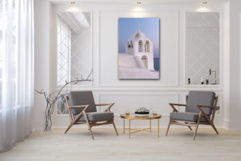 Large unframed lumachrome fine art print of a church in Santorini Greece displayed in the living room of a modern home