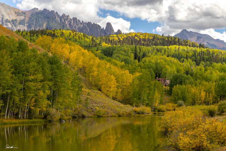 image of a beautiful mountain cabin on a lake in Telluride Colorado with fall colors in the trees