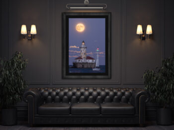 large fine art framed print of a super moon rising behind Chicago's Navy Pier lighthouse with a sailboat crossing in front displayed in the lounge of a luxury hotel