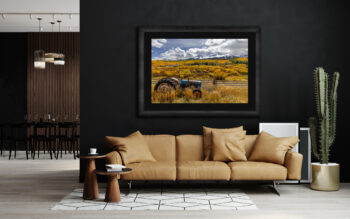 large framed fine art print of a tractor in Telluride Colorado during fall displayed in the living room of a modern luxury home