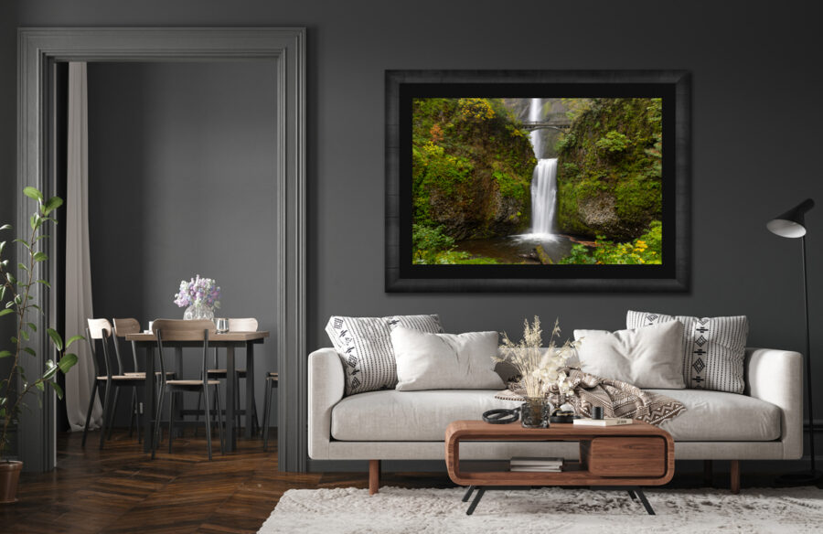 Large framed fine art print of a waterfall in Oregon displayed in the living room of a modern home