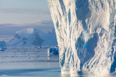 image of massive sea ice structures down in Antarctica with mountains in the background