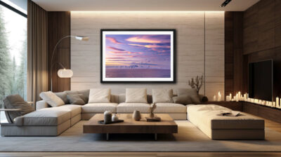 Large framed fine art print of a sunset over Antarctica displayed in the living room of a modern mansion