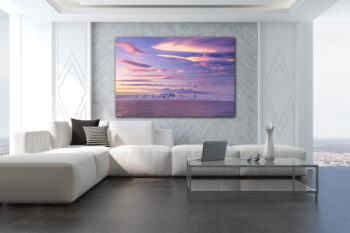 Unframed fine art print of a sunset over Antarctica with pink clouds displayed in a luxury living room