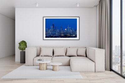 Large fine art framed print of the Chicago skyline displayed in a modern condo living room