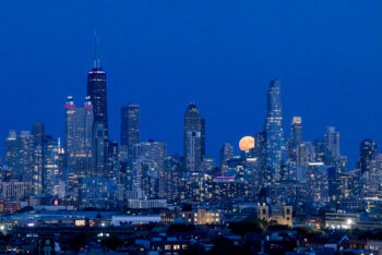 photograph of a full moon rising over Chicago at dusk