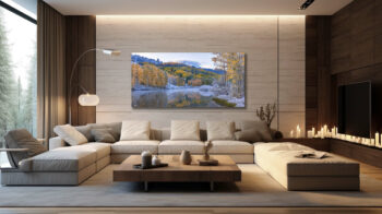 Large panoramic fine art print of snow in the mountains of colorado during fall displayed in the living room of a luxury home