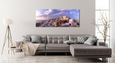 Large unframed print of Oia in Greece displayed in the living room of a modern home