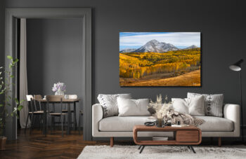 Large unframed fine art print of a mountain in colorado during fall displayed in the living room of a modern home