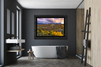 Large framed fine art print of the San Juan Mountains during fall at sunset displayed in the bathroom of a luxury home