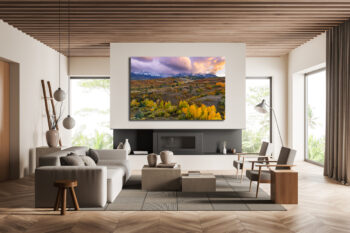 Large unframed fine art print of the San Juan Mountains during fall at sunset displayed in the living room of a modern home