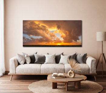 Large unframed fine art photographic print of a sunset over a farm displayed in a modern country home