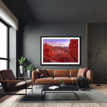 Large framed fine art print of Bryce Canyon at sunrise displayed in a modern apartment