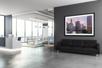 Large framed fine art print of the Chicago riverfront at sunrise displayed in a modern office building