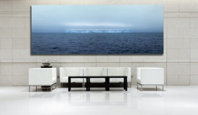 Extremely Large fine art print of an iceberg drifting out at sea displayed in the lobby of a luxury hotel