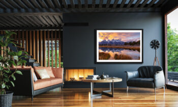 Image of a large framed fine art photo of the Grand Teton National Park displayed in the living room of a luxury home