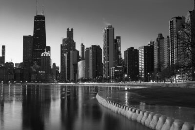 Black and white photo of Chicago from North Avenue Beach with the city skyline in the background.